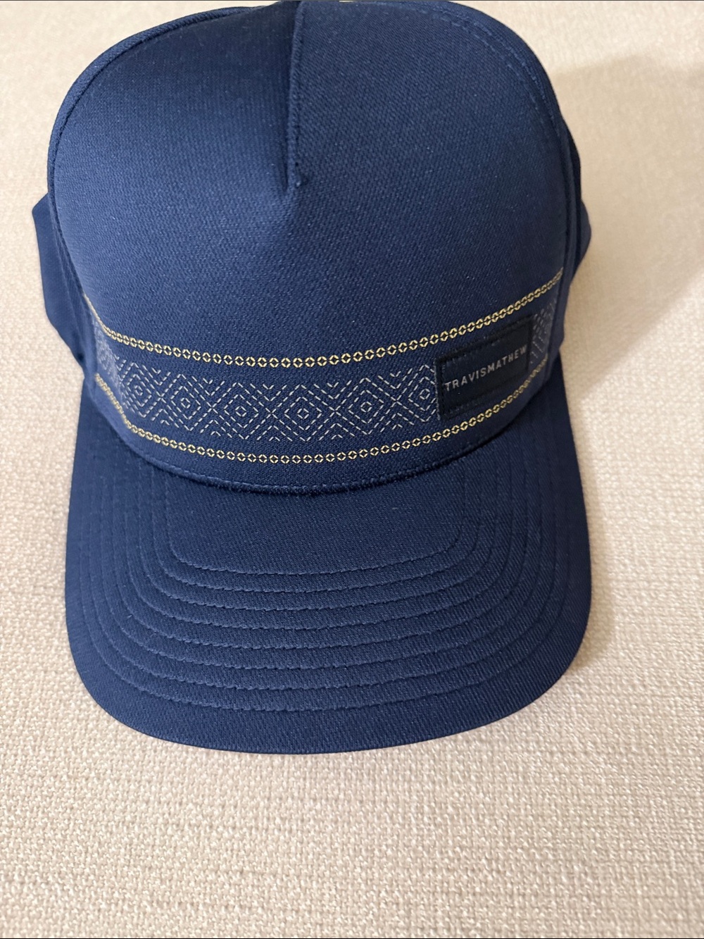 NWOT Travis Mathew Navy Cap with Gold Embroidered Band